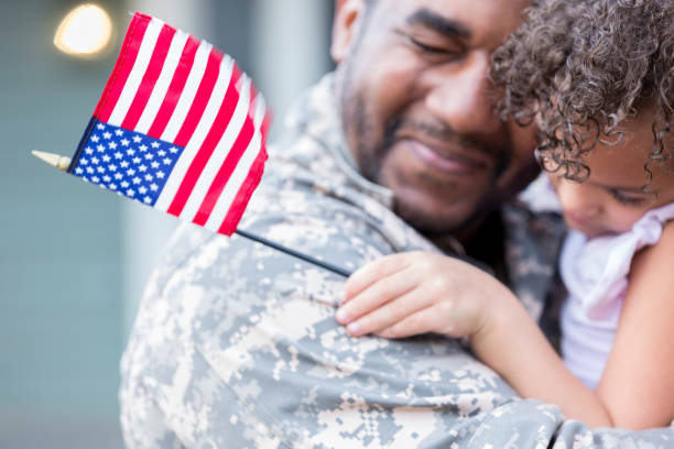 Sad military soldier says goodbye to his little girl Upset soldier holds his little girl tight while saying goodbye to her. He is leaving for long overseas assignment. military lifestyle stock pictures, royalty-free photos & images