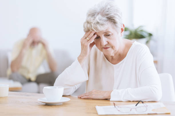 Sad senior woman after quarrel Sad senior woman sitting at table after a quarrel with her husband dementia stock pictures, royalty-free photos & images