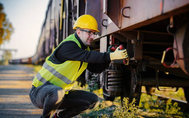 Safety first. Technician controls correctness of the freight car. Transportation concept stock photo
