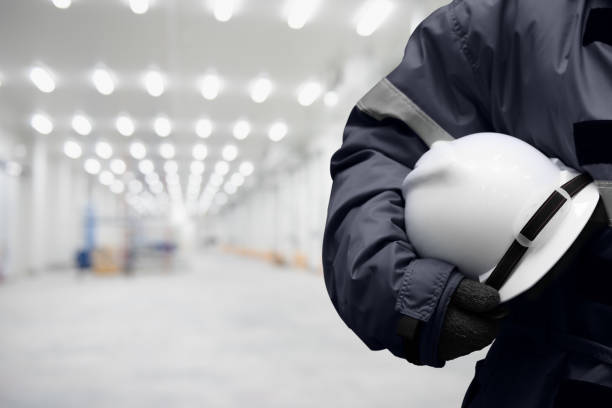 Safety hardhat for dangerous accident protection in warehouse during work. Cold room storage and freezing warehouse. copy space for text. stock photo