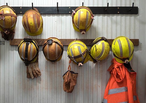 Safety helmets Safety helmets and gloves hang from a rack on a mining site mining natural resources stock pictures, royalty-free photos & images
