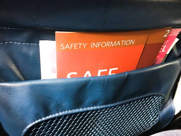 Safety Information in Airplane Seat Back A safety information packet in the back of a plane seat pocket. airplane seat stock pictures, royalty-free photos & images