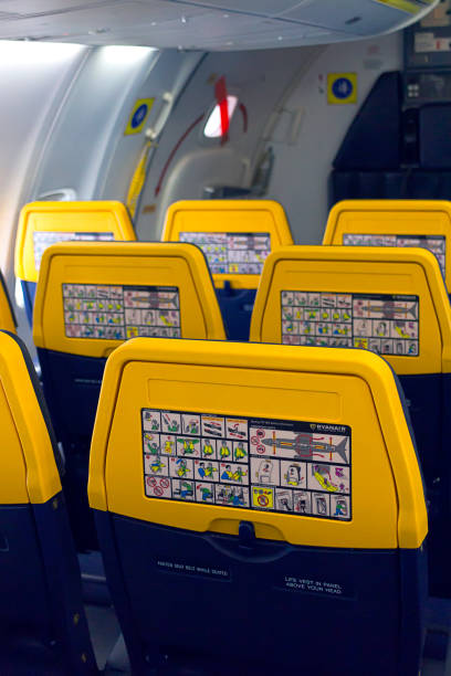 Safety informations panel on a Boeing Ryanair, showing what you need to do in case of an emergency landing - Flight from Madrid to Milan - Defocused background stock photo