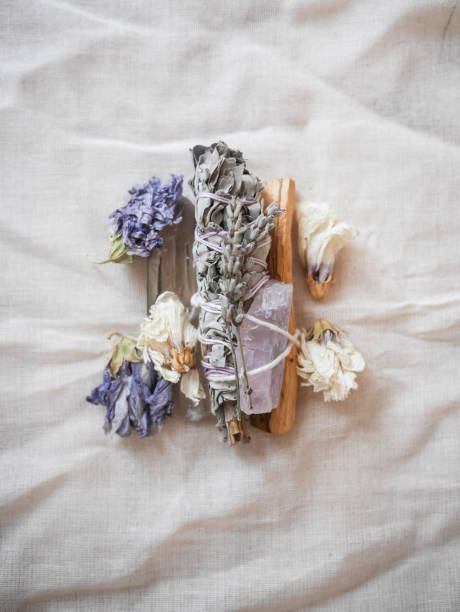 Sage bundle with crystals and flowers Sage bundle with crystals and dried purple flowers. sage stock pictures, royalty-free photos & images