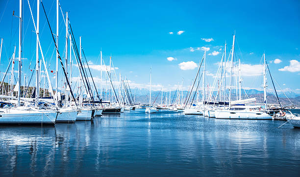 Sail boat harbor Sailboat harbor, many beautiful moored sail yachts in the sea port, modern water transport, summertime vacation, luxury lifestyle and wealth concept marina stock pictures, royalty-free photos & images