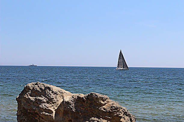 Sailing boat floats on the sea stock photo