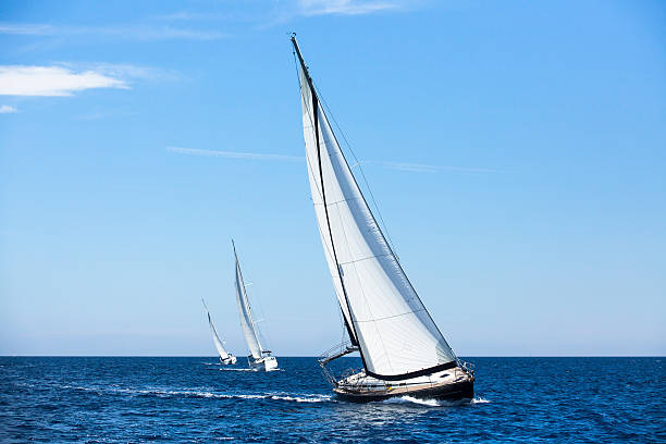 Sailing ship yachts with white sails. Luxury yachts. stock photo