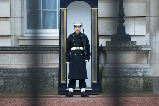 Sailor from the Royal Navy keeping Guard at Buckingham Palace. A duty traditionally performed by the Coldstream Guards, has recently been passed onto the Royal Navy (The first Royal Navy 'Changing the Guard' took place at Buckingham Palace on Sunday November 26, 2017.) Nearly 90 sailors from 45 Royal Navy Ships and establishments are being taught the intricate routines and drill movements needed for the historic royal guarding duties at the Queen's London residence.