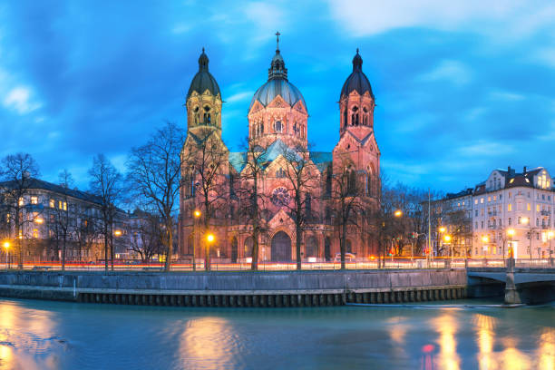 Saint Lucas Church at night in Munich, Germany Saint Lucas Church, the largest Protestant church in Munich, and Isar River at night, Bavaria, Germany river isar stock pictures, royalty-free photos & images