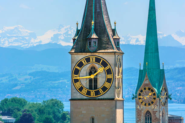Saint Peter and Fraumünster Church Saint Peter and Fraumünster Church in Zurich (Switzerland) in front of lake Zurich and the Swiss Alps zurich stock pictures, royalty-free photos & images