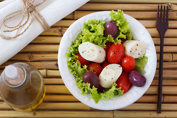 Salad of heart of palm (palmito), cherry tomatos, olives, pepper stock photo