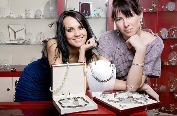 sales assistants Two friendly  sales assistants store clerk selling jewelry stock pictures, royalty-free photos & images