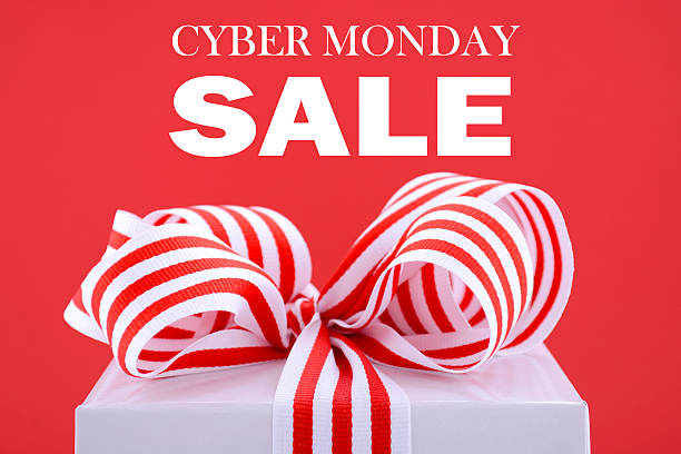 Sales Promotion Gift Box. Cyber Monday red and white sales promotion gift box closeup against a red background with sample text. cyber monday stock pictures, royalty-free photos & images