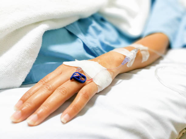 saline solution on a woman's hand in hospital Patient is on drip receiving saline solution  infusion therapy stock pictures, royalty-free photos & images