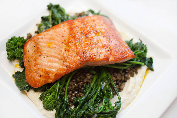 Salmon Filet Seared salmon on a bed of parsnip puree with french lentils and broccoli rabe broccoli rabe stock pictures, royalty-free photos & images