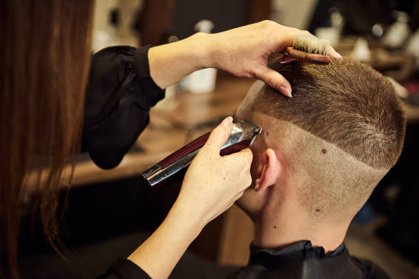 Salon. Man in a barber chair. The hairdresser serves the client in the barbershop. The concept of male cosmetology. stock photo