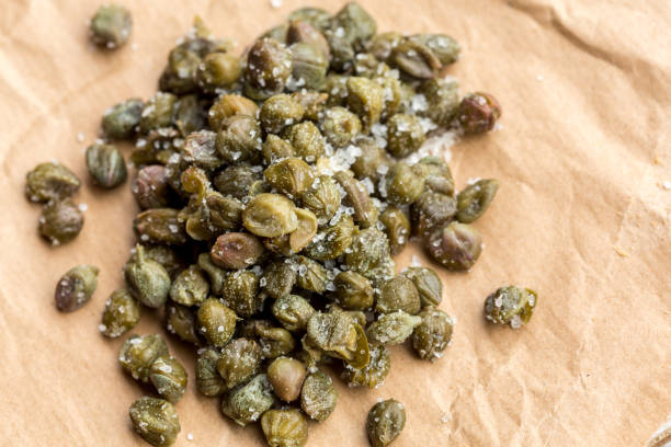 Salted capers from Pantelleria island Salted capers from Pantelleria island on paper caper stock pictures, royalty-free photos & images