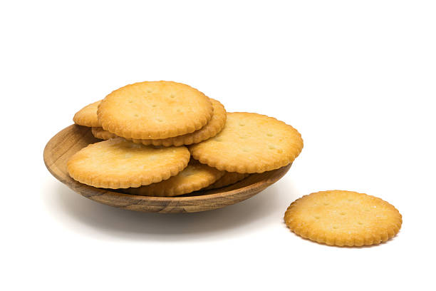 Salted round cracker in a wooden plate stock photo