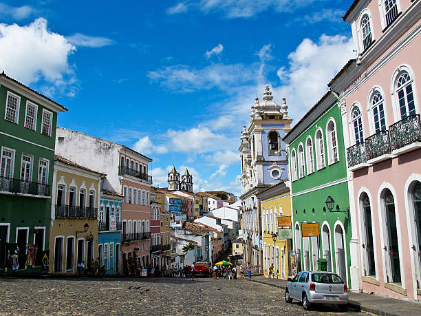 Salvador Brazil Pelourinho´s Street in a Sunny Summer Day Salvador, Bahia State, Brazil - January 8, 2014: Tourists walk in the Historic Largo do Pelourinho neighborhood in a hot Summer day. It is located in the city´s Historical Centre with Portuguese baroque architecture style. pelourinho stock pictures, royalty-free photos & images