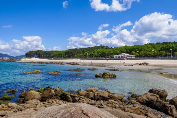 Samil beach in Vigo, Galicia, Pontevedra, Spain. Rocks, sea, trees and a restaurant stock photo