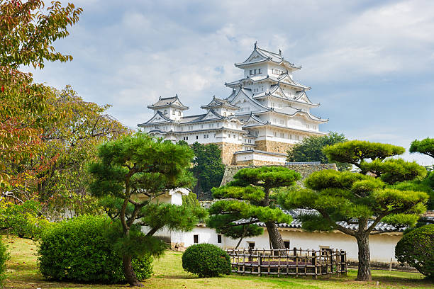 Samurai Himeji Castle with Red Fall Leafs in Japan stock photo