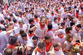 Pamplona, Spain - July 6, 2012: A woman sitting on shoulders are having fun at opening of  San Fermin festival. Plaza in front of municipality.