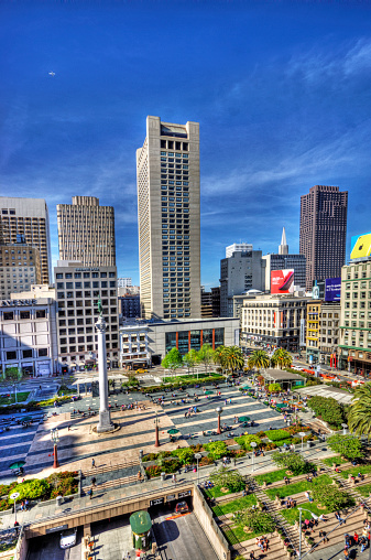 San Francisco, USA - April 14, 2014: HDR image of San Francisco architecture in Union Square with high rise buildings and people and traffic in the square below.
