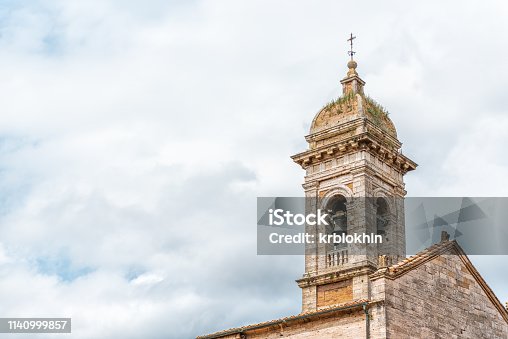 istock San Quirico D'Orcia, Italy small historic medieval town village in Tuscany and famous church bell tower closeup isolated against sky 1140999857