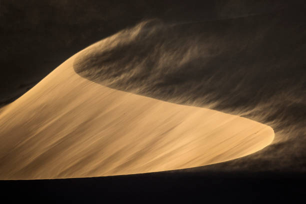 Sand blowing off a sand dune. stock photo