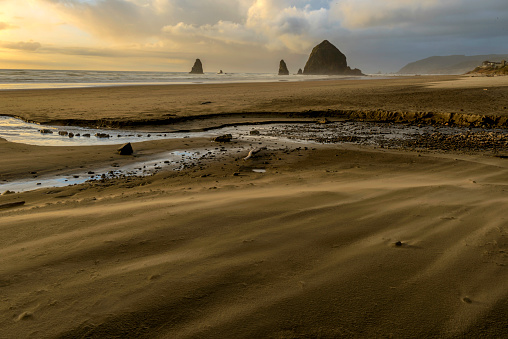 Sunset at Cannon Beach with sand blowing