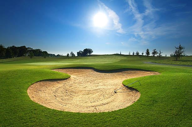 Sand bunker on empty golf course with blue sky stock photo