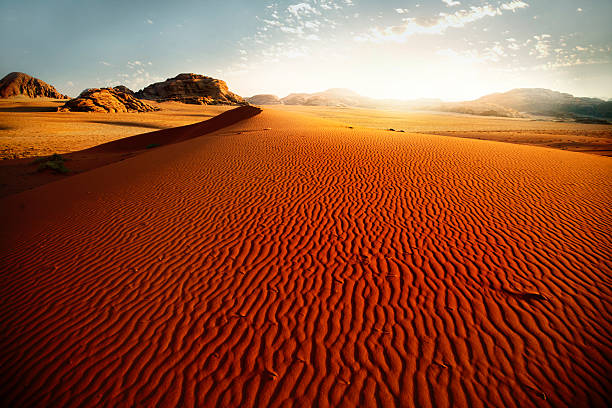 Sand dune at sunrise stock photo