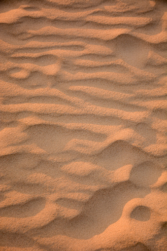 Sand in wave like formations at sunset