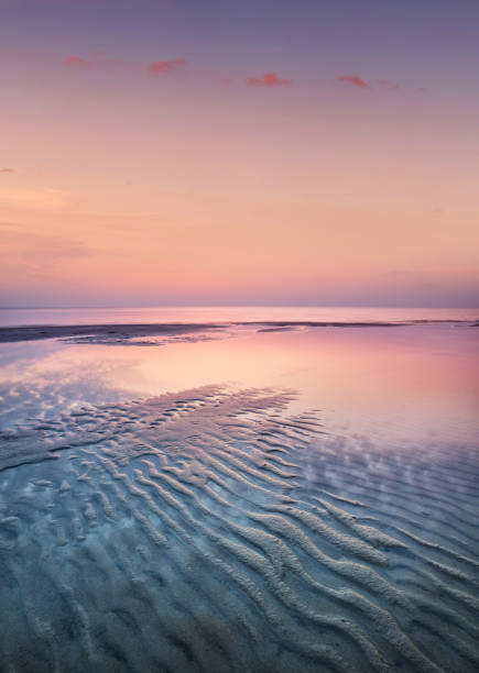 Sand on the seashore during sunset stock photo