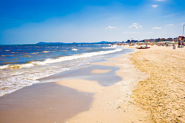 Sand, surf and water on an Italian beach A beach in Adriatic sea, Rimini, Italy adriatic sea stock pictures, royalty-free photos & images