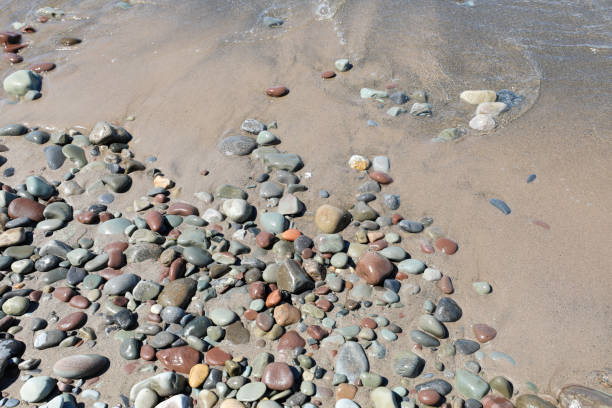 Sand washed pebbles on a beach. stock photo