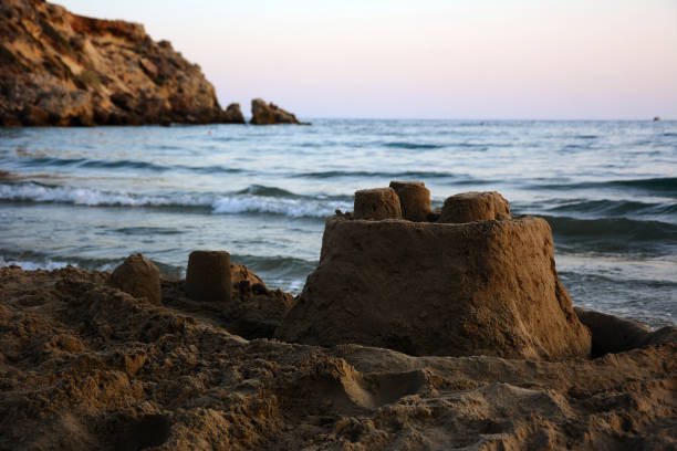 Sandcastle on the seashore in the evening. stock photo
