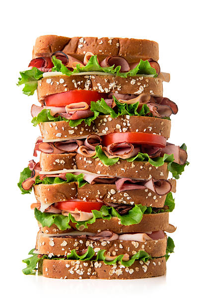 Sandich Tall multi-layered sandwich.  Please see my portfolio for other food and drink images.  roast beef sandwich stock pictures, royalty-free photos & images