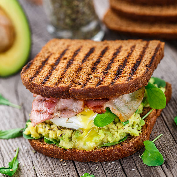 Sandwich with avocado and poached egg stock photo
