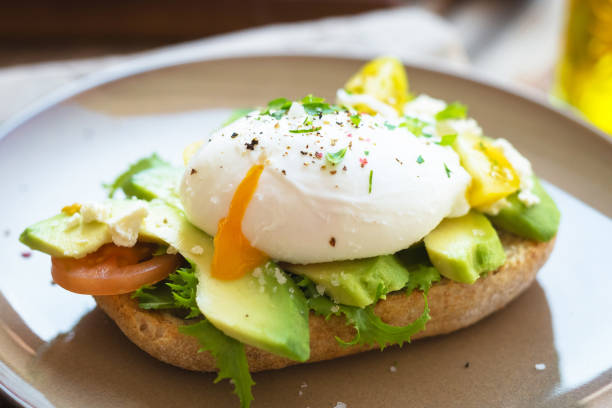 Sandwich with avocado and poached egg Sandwich with avocado and poached egg poached food photos stock pictures, royalty-free photos & images