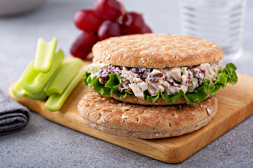 Sandwich with chicken salad with celery sticks and grapes, lunch to go