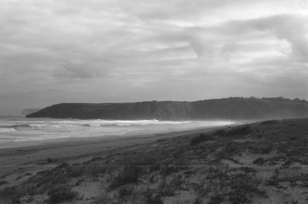 Sandy beach in black and white stock photo