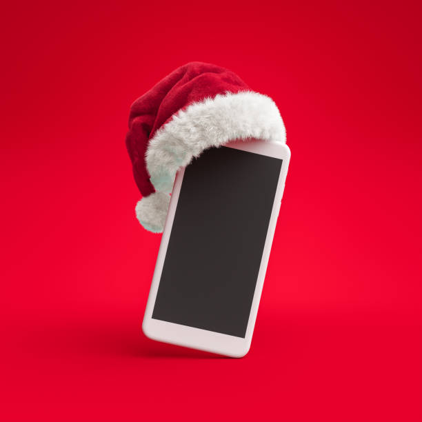 santa claus hat put on smartphone, christmas online shopping concept banner, 3d rendering - smartphone christmas imagens e fotografias de stock
