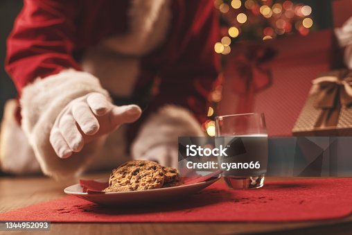 istock Santa Claus having a delicious snack 1344952093