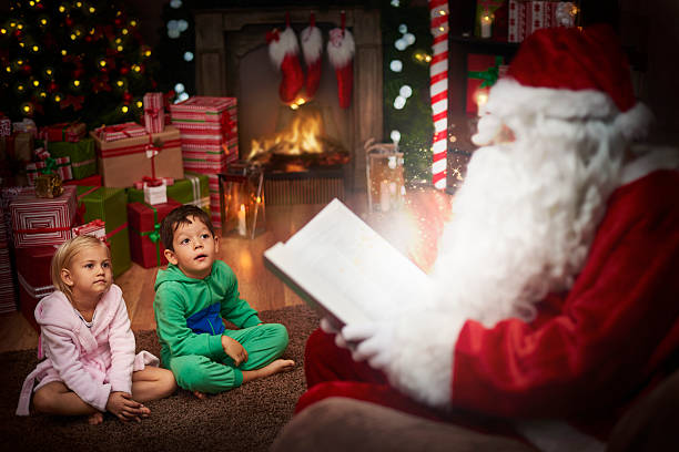Santa claus is the best story teller Santa claus is the best story teller christmas story telling stock pictures, royalty-free photos & images