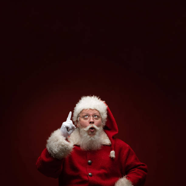 Santa Claus pointing up stock photo