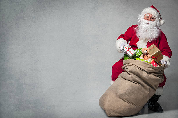 Santa Claus with a bag of presents stock photo