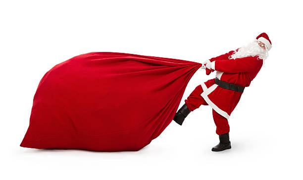 Santa Claus with huge bag of presents Santa Claus pulling huge bag full of christmas presents isolated on white background sack stock pictures, royalty-free photos & images