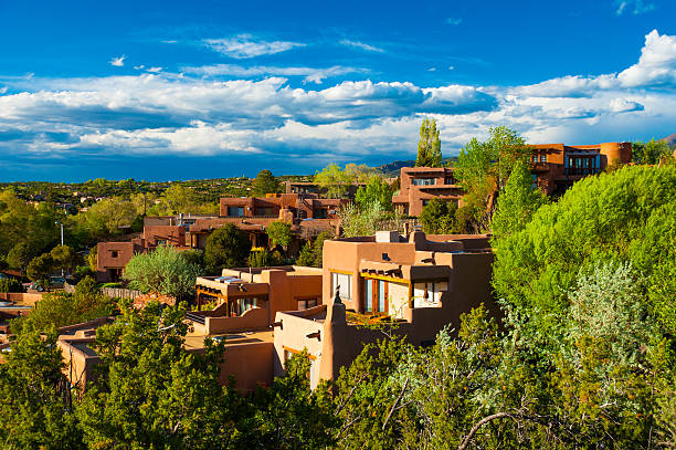 Santa Fe hillside houses Hillside houses and trees in Santa Fe, New Mexico, with  clouds in the background. new mexico stock pictures, royalty-free photos & images