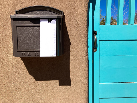 Santa Fe, NM: Sunlit Adobe Wall, Blue Door, Mailbox with Letter